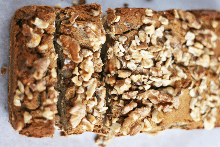 Image of the best paleo banana recipe served up on a white piece of parchment paper and topped with walnuts