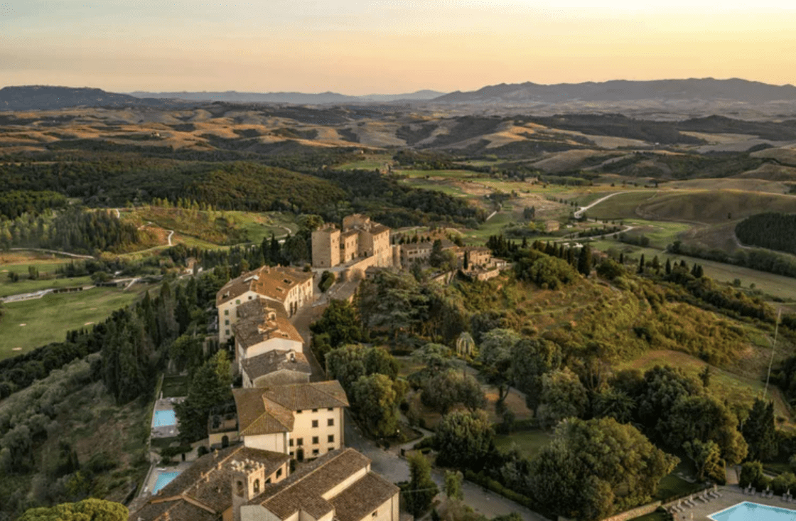 Image of a view of Castelfalfi's massive property from above, which includes 57 acres of vineyards, a castle, and 9000 olive trees.