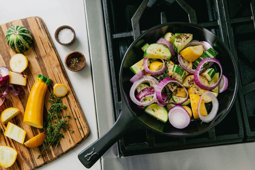Image of an Xtrema pure ceramic black skillet on a stovetop — ceramic cookware pros and cons include its ability to heat evenly with no hot spots.