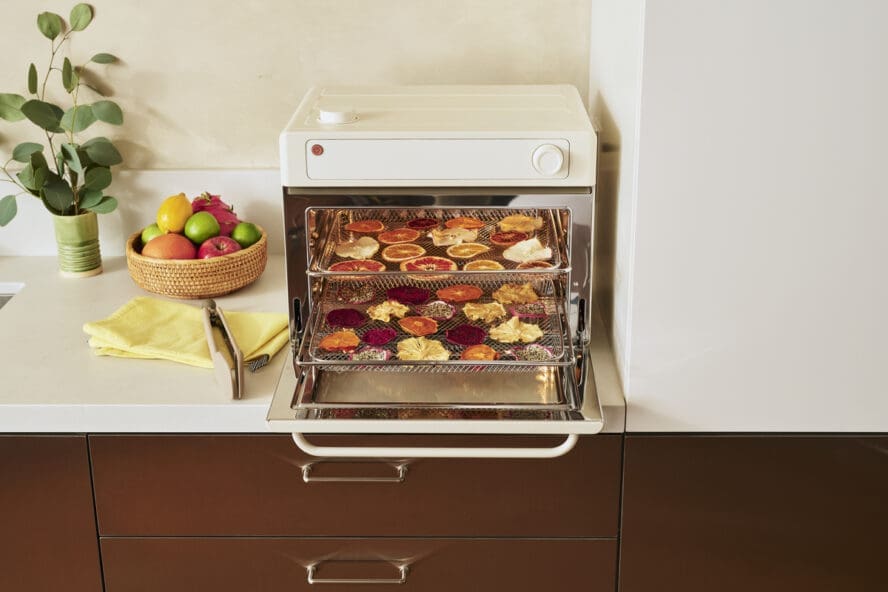 Image of the Our Place Wonder Oven Pro in Cream, with a tray of dehydrated citrus fruit.