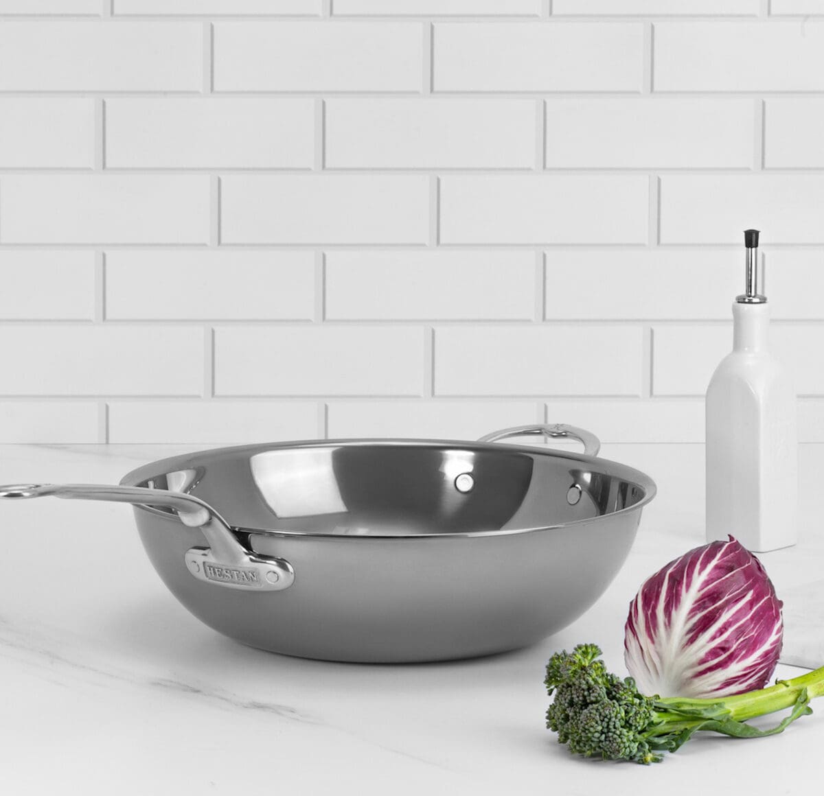 Image of a Hestan NanoBond pan on a white countertop next to a wedge of cabbage.