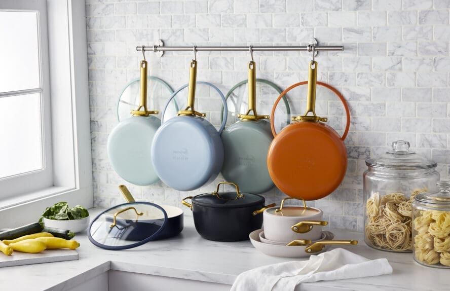 Image of GreenPan ReseGreenPan Reserve Pro Review cookware handing on a wall with matching lids.