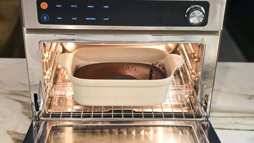 Image of the Our Place Wonder Oven Pro in stainless steel being used to bake a pan of chocolate bread.
