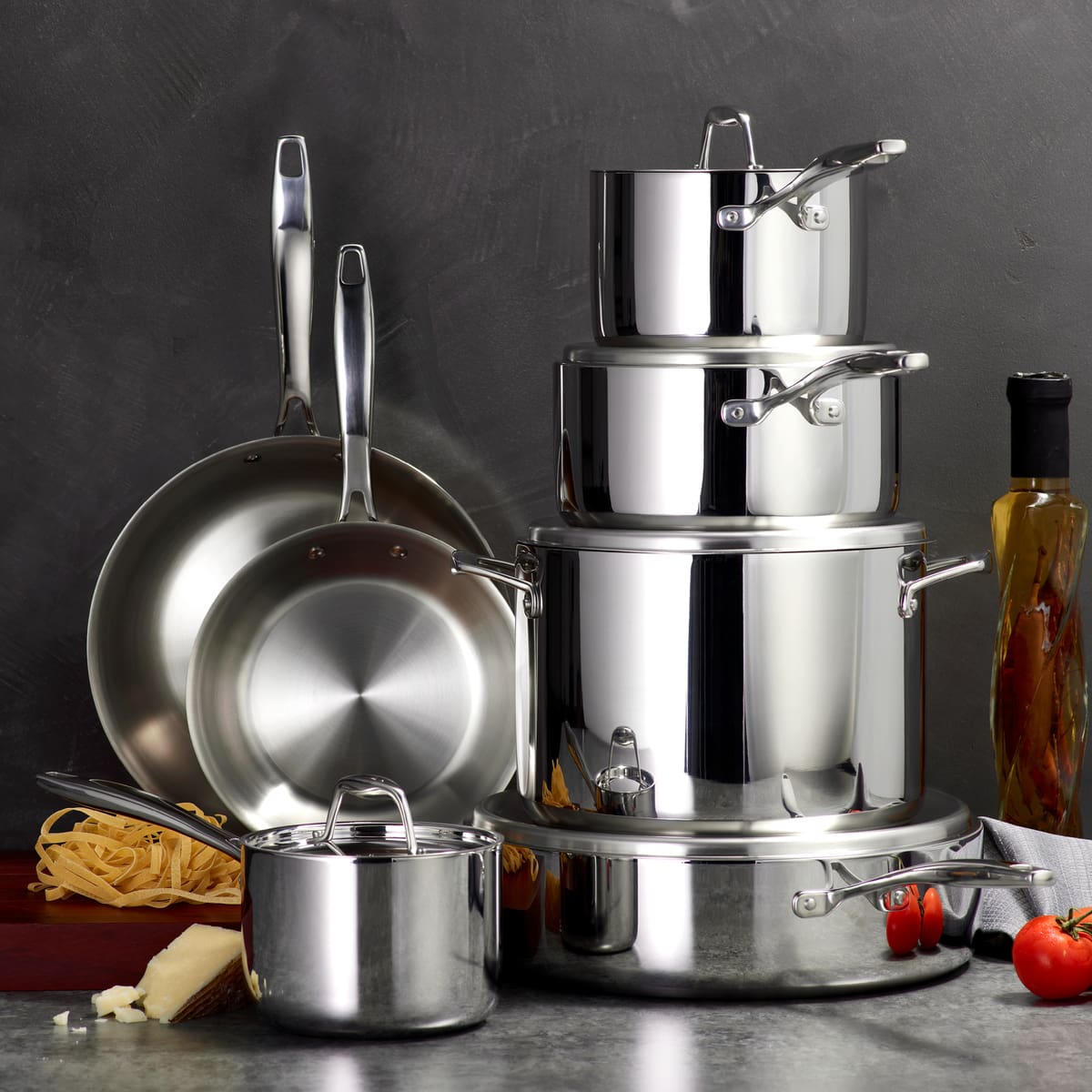 Image of the Tramontina 12-piece stainless steel cookware set nested and stacked on a grey countertop.